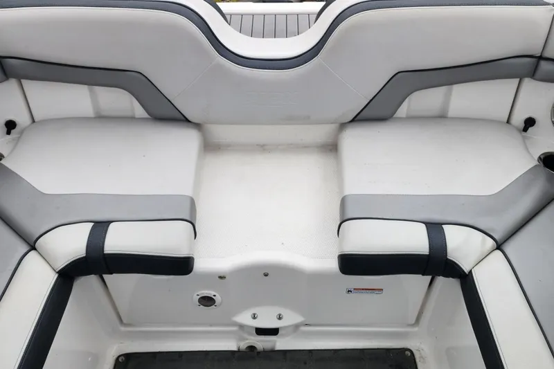 Slide: The Image of 2015 Yamaha Boats 212X interior seating, featuring gray and white cushioned design. - 32