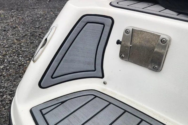 Slide: The Image of 2015 Yamaha Boats 212X swim platform with textured gray padding and metal fixture. - 38