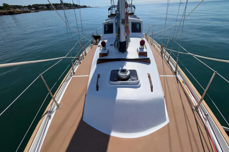 Slide: The Image of 1982 Shannon Pilothouse sailboat deck on calm waters, showcasing rigging and cabin. - 16