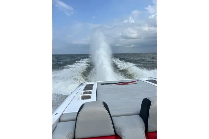 Slide: The Image of 2007 Donzi 38 ZR speedboat cruising on open water, leaving a powerful wake. - 10