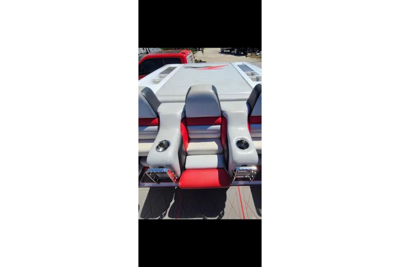 Slide: The Image of 2007 Donzi 38 ZR boat with red and gray seating and cup holders. - 11
