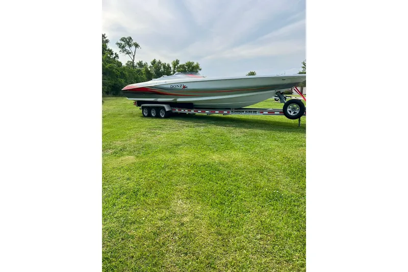 Slide: The Image of 2007 Donzi 38 ZR speedboat on trailer, parked on grassy field. - 15