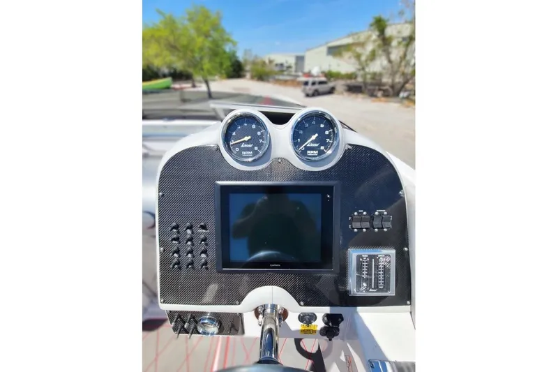 Slide: The Image of Dashboard of a 2007 Donzi 38 ZR boat with gauges and touchscreen display. - 8