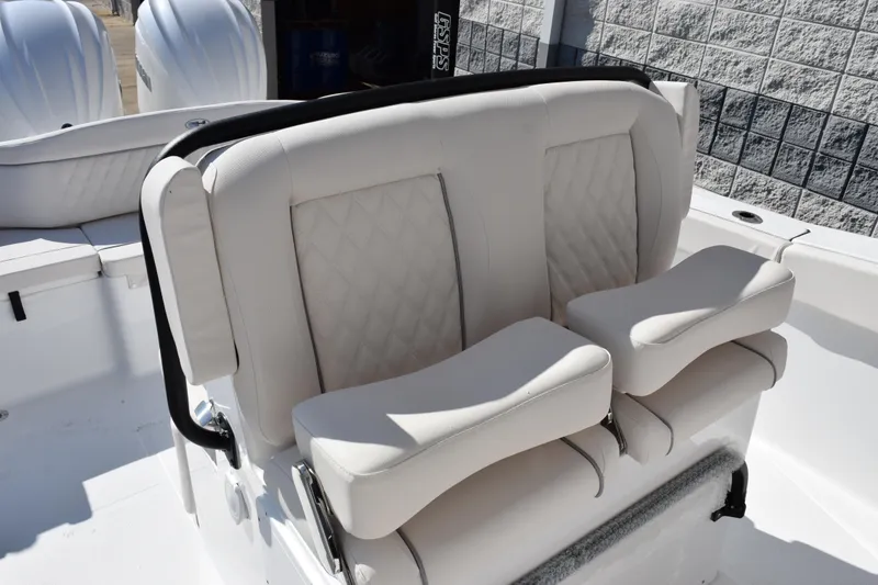 Slide: The Image of 2026 Sea Hunt Ultra 275 SE boat seating with cushioned armrests and quilted upholstery. - 11