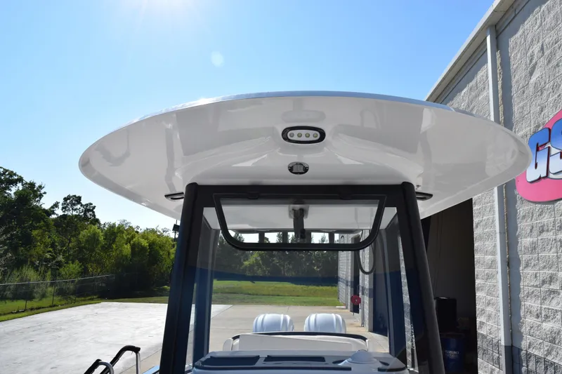 Slide: The Image of 2026 Sea Hunt Ultra 275 SE boat with sleek T-top design under clear blue sky. - 14