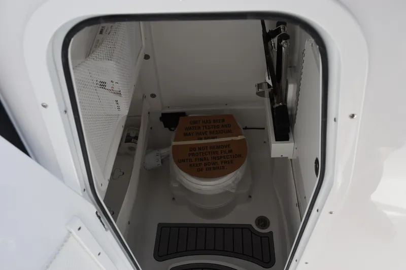 Slide: The Image of Interior view of 2026 Sea Hunt Ultra 275 SE boat compartment with toilet. - 17