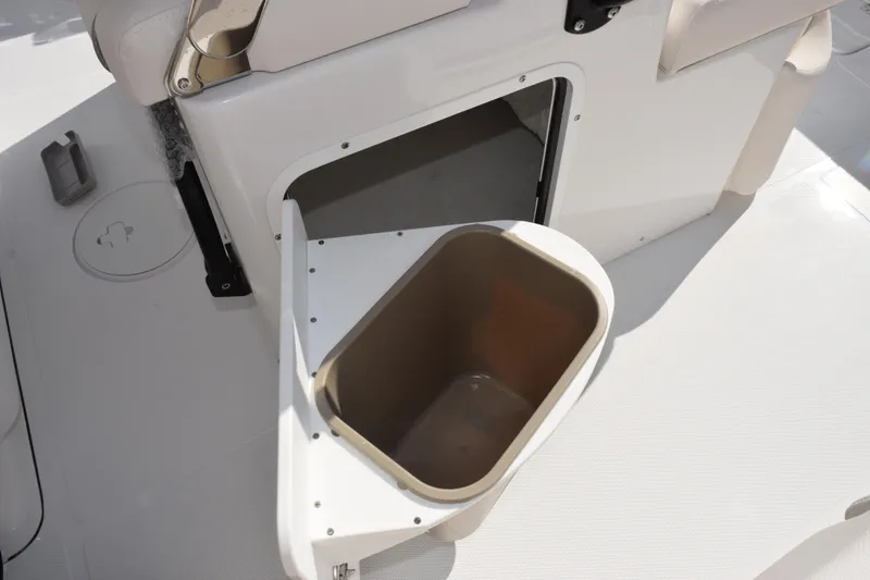 Slide: The Image of Storage compartment with bin on 2026 Sea Hunt Ultra 275 SE boat. - 19