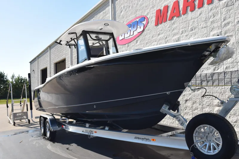 Slide: The Image of 2026 Sea Hunt Ultra 275 SE boat on trailer outside marine dealership. - 2