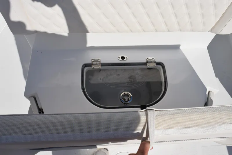 Slide: The Image of 2026 Sea Hunt Ultra 275 SE boat storage compartment with cushioned seating. - 20