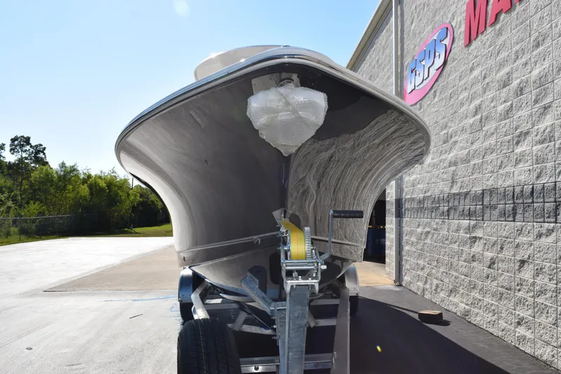 Slide: The Image of 2026 Sea Hunt Ultra 275 SE boat on trailer outside marine store. - 3