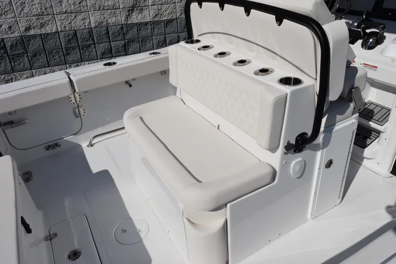 Slide: The Image of 2026 Sea Hunt Ultra 275 SE boat interior with cushioned seating and cup holders. - 8