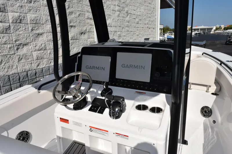 Slide: The Image of 2026 Sea Hunt Ultra 275 SE boat dashboard with Garmin displays and steering wheel. - 9