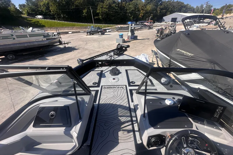 Slide: The Image of 2026 Smoker Craft Adventurer 188 DC boat interior with modern dashboard and controls. - 10