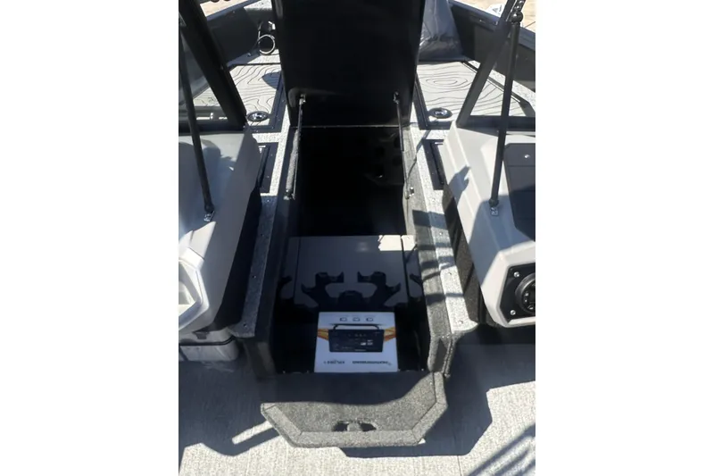 Slide: The Image of 2026 Smoker Craft Adventurer 188 DC boat interior with open storage compartment. - 6