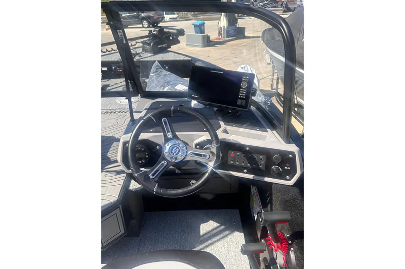 Slide: The Image of 2026 Smoker Craft Adventurer 188 DC boat dashboard with steering wheel and control panel. - 7
