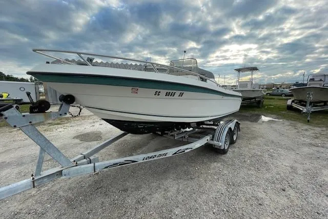 Slide: The Image of 1994 Wahoo 2050 efs boat on trailer under cloudy sky. - 2