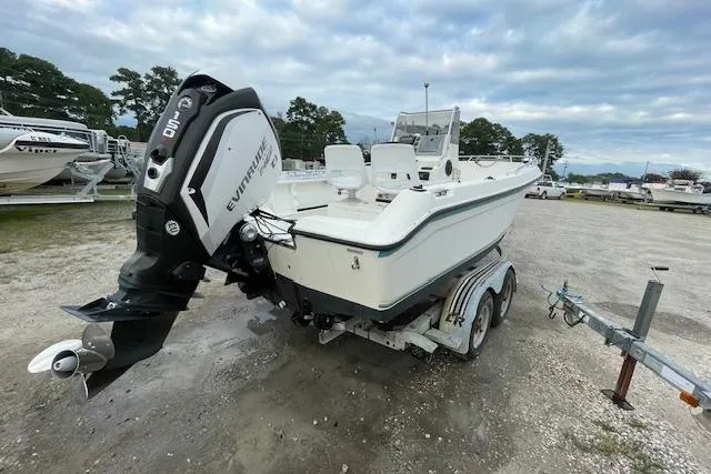 Slide: The Image of 1994 Wahoo 2050 efs boat on trailer with Evinrude outboard motor. - 5