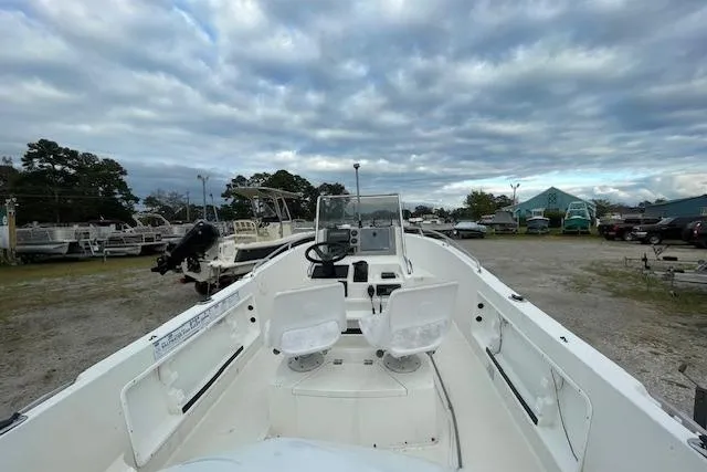 Slide: The Image of 1994 Wahoo 2050 efs boat with dual seats, parked outdoors under cloudy skies. - 6
