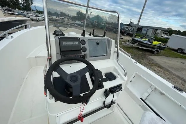 Slide: The Image of 1994 Wahoo 2050 efs boat console with steering wheel and Evinrude controls. - 7