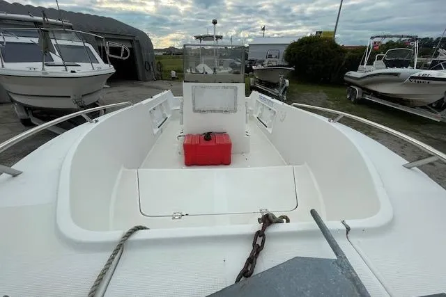 Slide: The Image of 1994 Wahoo 2050 efs boat with red fuel tank, docked outdoors. - 9