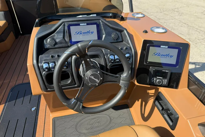 Slide: The Image of 2025 Bentley Pontoons Elite 223 Swingback dashboard with steering wheel and digital displays. - 10