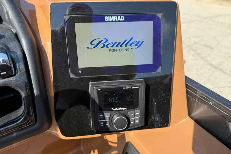 Slide: The Image of Dashboard of 2025 Bentley Pontoons Elite 223 Swingback with Simrad display and audio controls. - 11