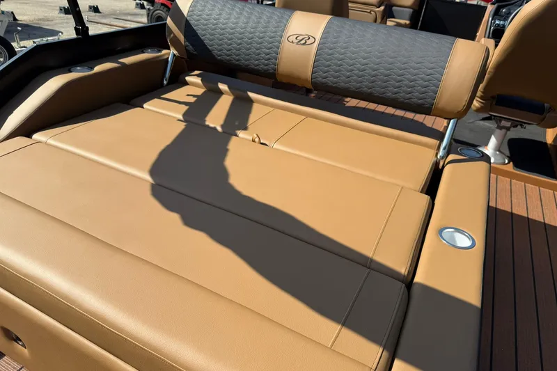 Slide: The Image of 2025 Bentley Pontoons Elite 223 Swingback with tan leather seating and cup holders. - 13