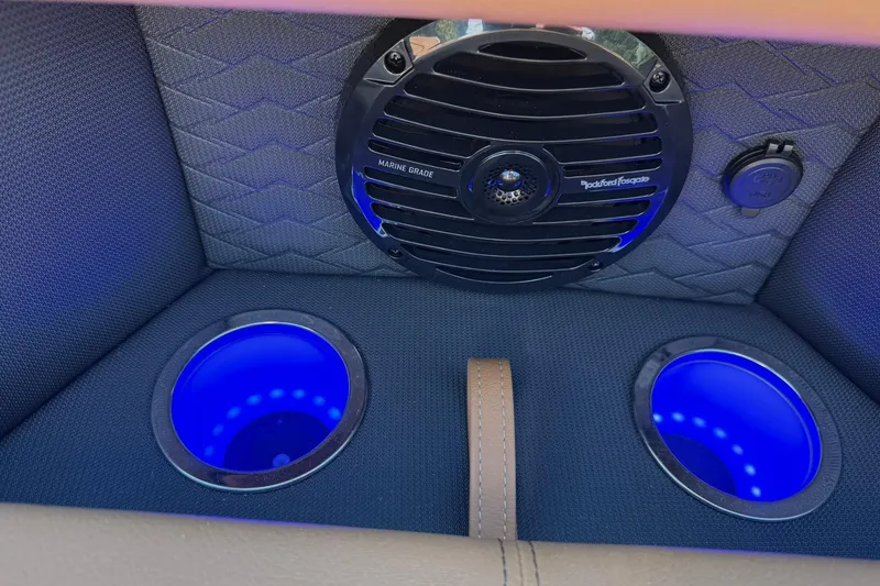 Slide: The Image of 2025 Bentley Pontoons Elite 223 Swingback interior with marine-grade speaker and illuminated cup holders. - 14