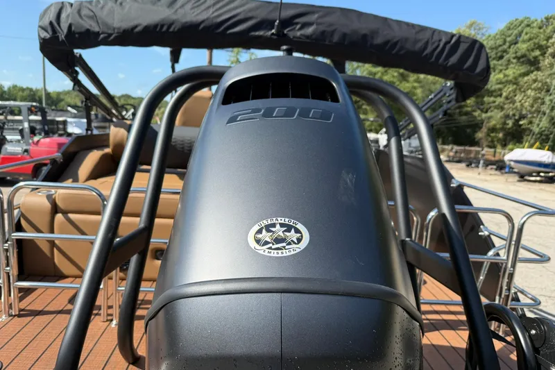 Slide: The Image of 2025 Bentley Pontoons Elite 223 Swingback with ultra-low emission engine, outdoor setting. - 15