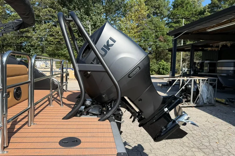 Slide: The Image of 2025 Bentley Pontoons Elite 223 Swingback with Suzuki outboard motor, docked outdoors. - 16