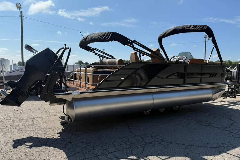 Slide: The Image of 2025 Bentley Pontoons Elite 223 Swingback on pavement under clear blue sky. - 4