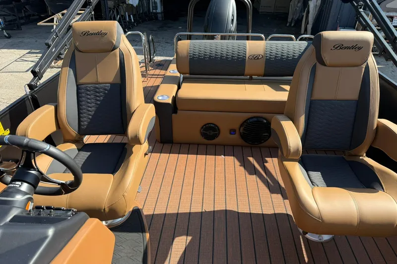Slide: The Image of 2025 Bentley Pontoons Elite 223 Swingback interior with luxurious tan and black seating. - 6