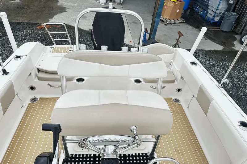 Slide: The Image of 2017 Robalo R180 Center Console boat interior with beige seating and steering wheel. - 11