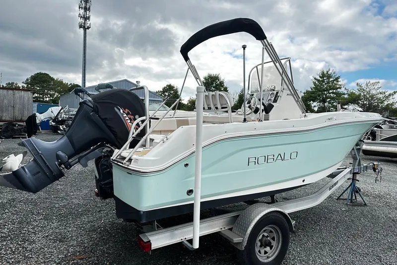 Slide: The Image of 2017 Robalo R180 Center Console boat on trailer, parked outdoors. - 3
