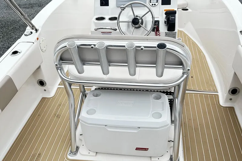 Slide: The Image of 2017 Robalo R180 Center Console boat interior with steering wheel and cooler. - 6