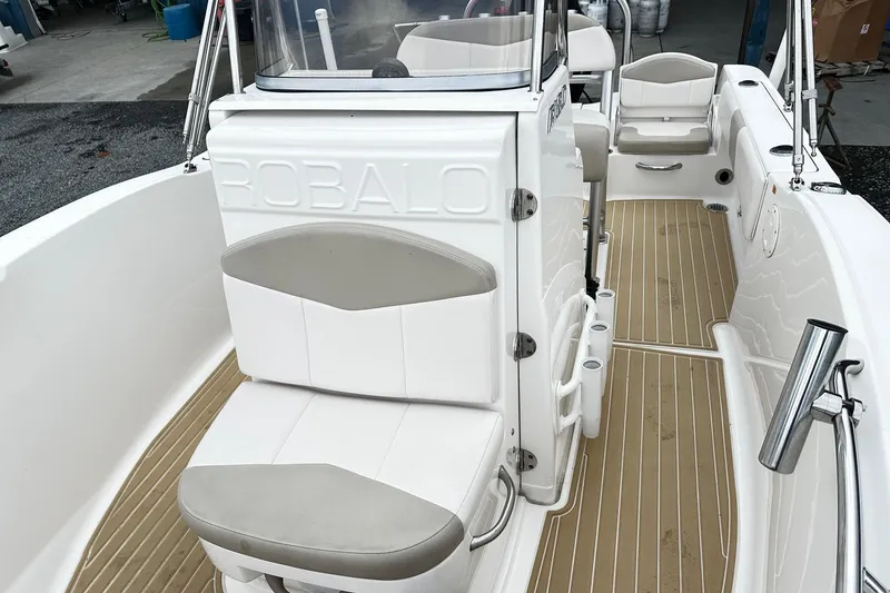 Slide: The Image of 2017 Robalo R180 Center Console boat interior with seating and deck view. - 7