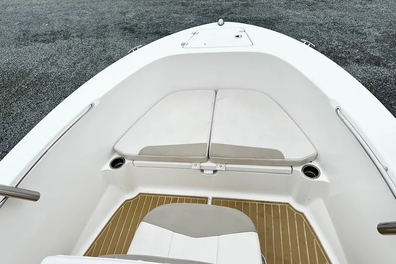 Slide: The Image of 2017 Robalo R180 Center Console boat interior with cushioned seating and cup holders. - 9