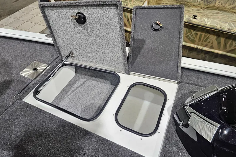 Slide: The Image of 2026 Lund 1875 Renegade boat storage compartments with open hatches, showcasing interior design. - 15