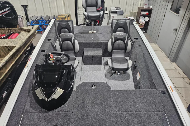 Slide: The Image of 2026 Lund 1875 Renegade boat interior with gray seating and steering console. - 16