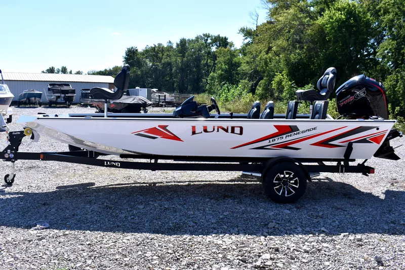 Slide: The Image of 2026 Lund 1875 Renegade fishing boat on trailer, parked outdoors. - 4