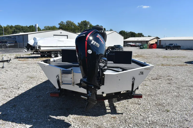 Slide: The Image of 2026 Lund 1875 Renegade boat with powerful outboard motor in a gravel lot. - 5