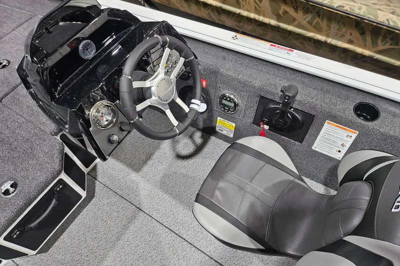 Slide: The Image of 2026 Lund 1875 Renegade boat interior with steering wheel and control panel. - 9
