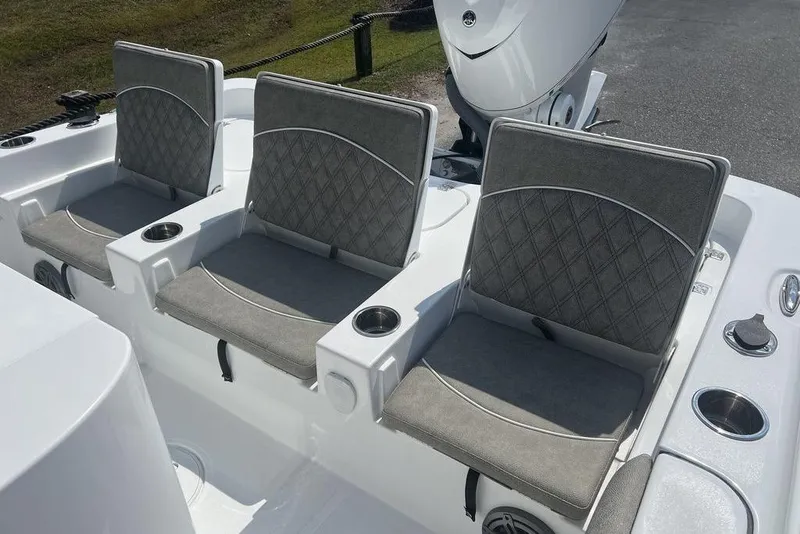 Slide: The Image of Three cushioned seats on a 2026 Sea Hunt BX 25 FS boat with cup holders. - 18