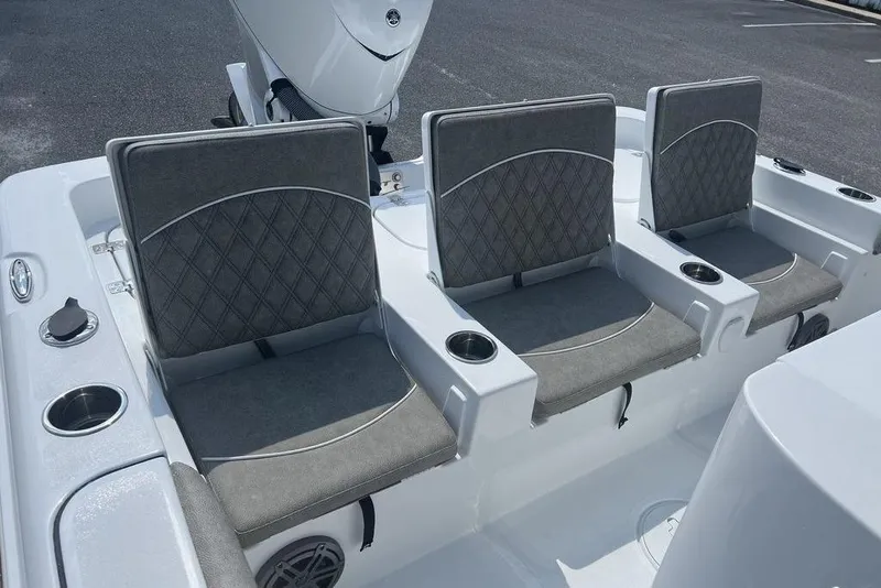 Slide: The Image of 2026 Sea Hunt BX 25 FS boat seating with gray cushions and cup holders. - 19