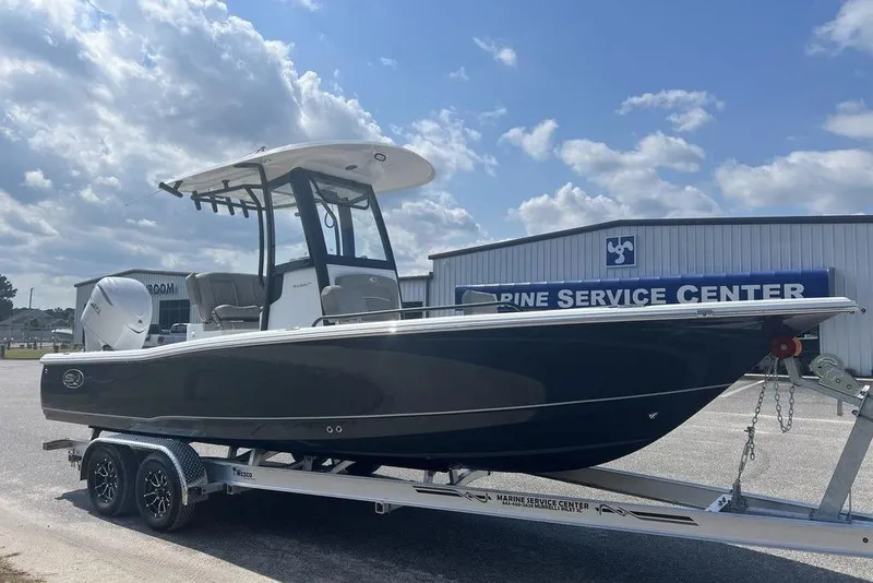 Slide: The Image of 2026 Sea Hunt BX 25 FS boat on trailer at marine service center. - 4