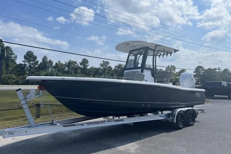 Slide: The Image of 2026 Sea Hunt BX 25 FS boat on trailer under a partly cloudy sky. - 5