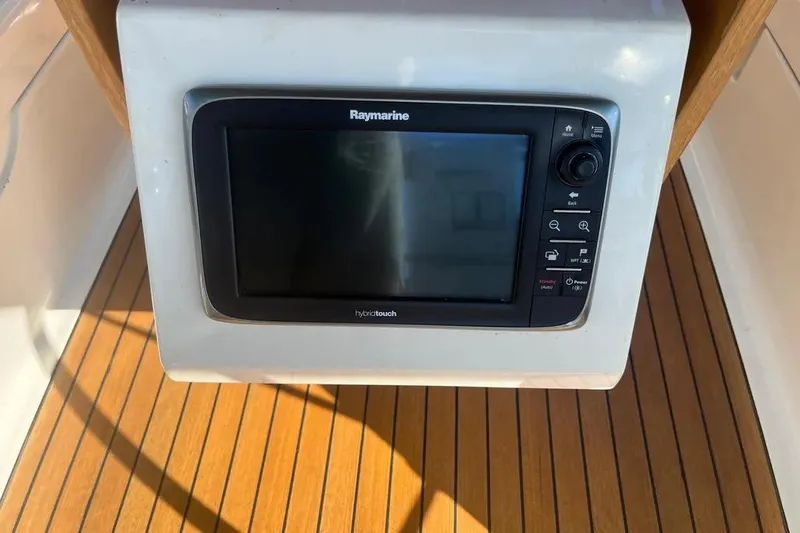 Slide: The Image of Raymarine navigation system on 2012 Delphia 47 yacht, wooden deck background. - 17