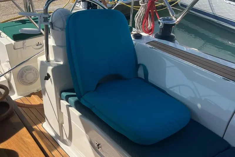 Slide: The Image of Blue cushioned seat on 2012 Delphia 47 yacht deck, with nautical equipment. - 28