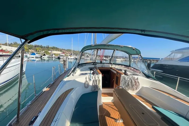 Slide: The Image of Delphia 47 yacht from 2012 docked at a marina, showcasing its spacious deck. - 3