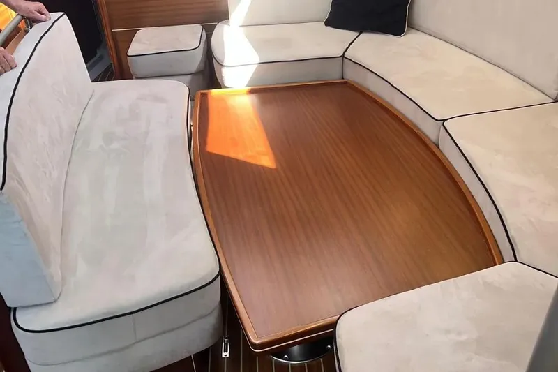 Slide: The Image of Luxurious interior of 2012 Delphia 47 yacht with elegant wooden table and plush seating. - 36